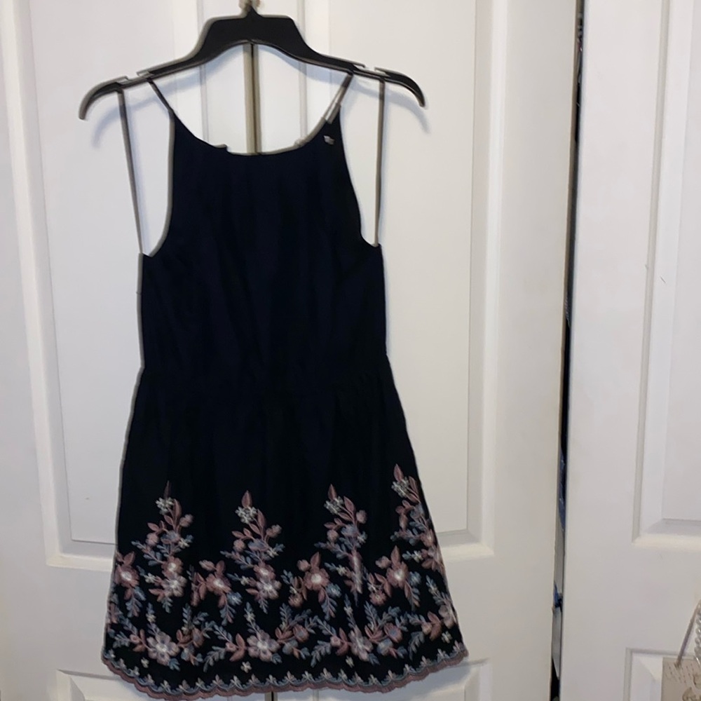 Francesca’s, Miami, Md, Black with floral embroidered design w/ scalloped edge.